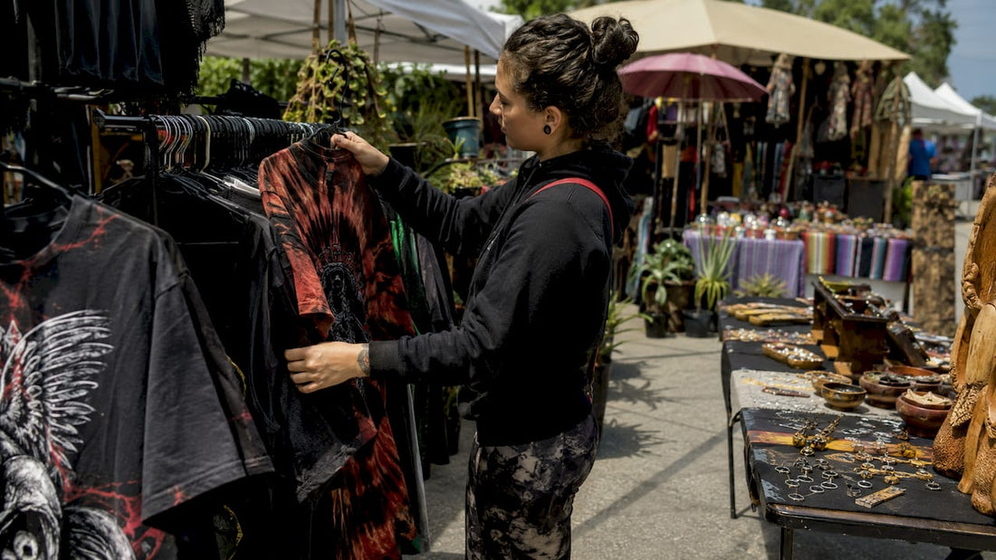 Shopper browsing heavyweight graphic tees in boutique