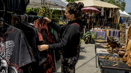 Shopper browsing heavyweight graphic tees in boutique