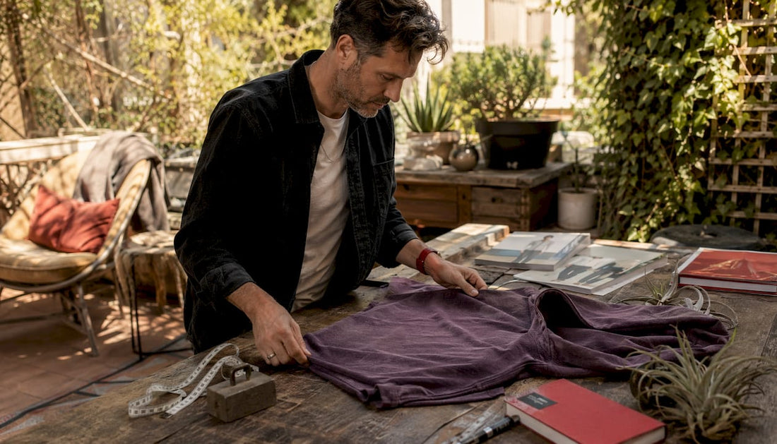 Expert examining vintage purple hoodie fabric closely
