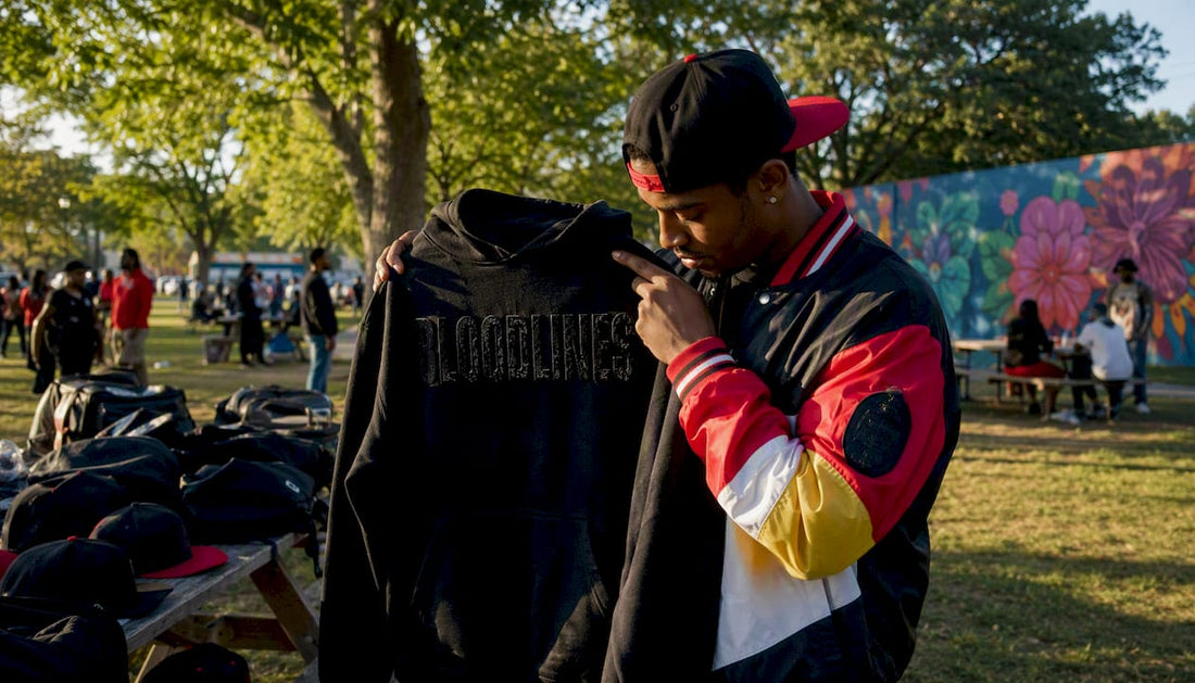 Man shopping for streetwear hoodie at outdoor market