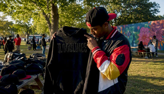 Man shopping for streetwear hoodie at outdoor market