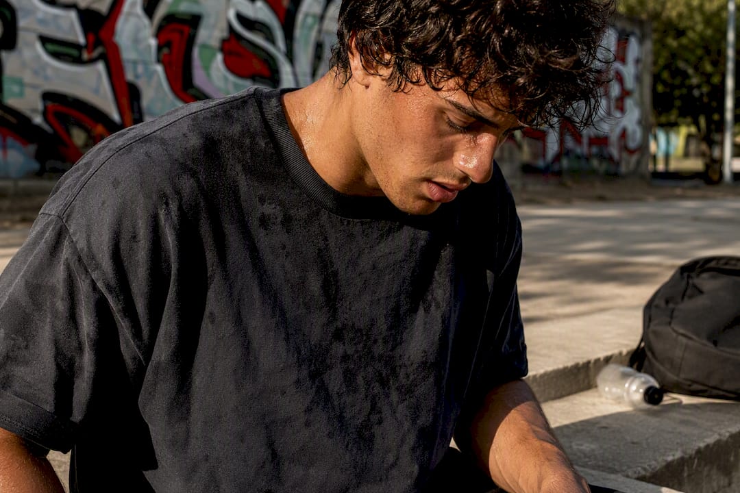 Athlete with damp wicking tee post-workout