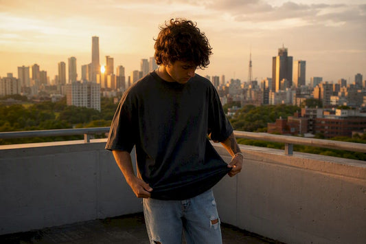 Man adjusting heavyweight oversized tee outdoors