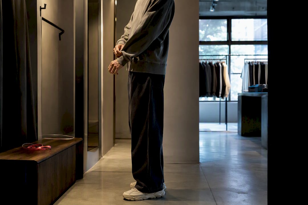 Tall man checking streetwear sleeve and hem fit