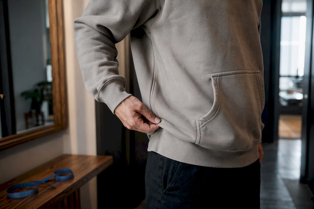 Person checking heavyweight hoodie fit